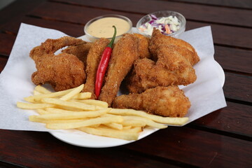 Spicy Fried Chicken with fries, mayo dip and salad served in a dish isolated on table side view of middle east food