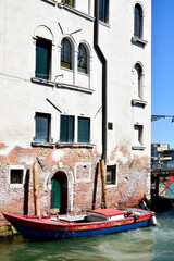 Fototapeta na wymiar Venice, Italy. Boat in canal near old building in Venice