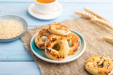 Homemade asian salted cookies, cup of green tea on blue wooden, side view.
