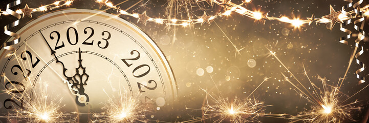 
2023 New Year - Vintage Clock Showing Countdown To Midnight On Abstract Defocused Background With Stars And Fireworks