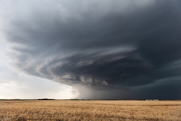 Storm clouds from a supercell thunderstorm over a field in Kansas