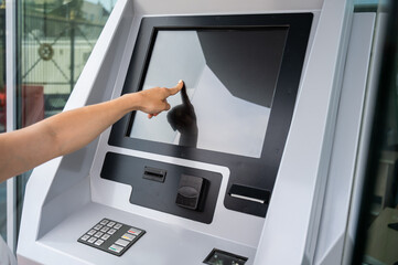 Caucasian woman buying tickets from the machine.