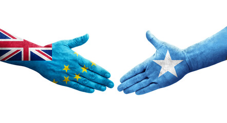Handshake between Tuvalu and Somalia flags painted on hands, isolated transparent image.