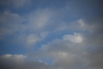 background of daytime cloudy sky white clouds rainy weather blue sky sun rays texture of sky and cirrus clouds in a city in Ukraine, atmosphere, peaceful sky stratosphere  before the rain 