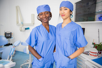 Two female doctors in the dental office, colleagues of different ethnicities