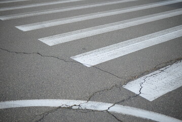 abstract lines pedestrian crossing background road markings white stripes on the asphalt road, parking spaces separated by white lines, symmetrical abstract lines on gray asphalt