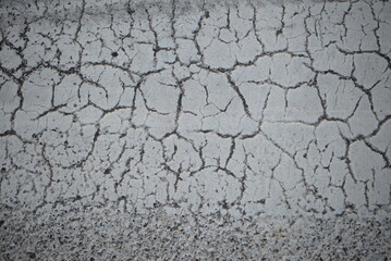 texture of white paint for road marking on asphalt, texture of painted asphalt cracked texture white background, white background on gray asphalt, pedestrian crossing, new road marking  close up 
