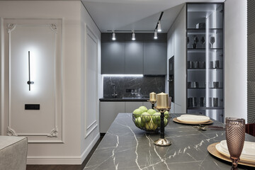 Modern interior of studio apartment in gray and  white colors and tones. White furniture and door....