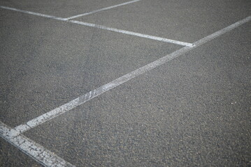 white lines abstract on asphalt, road markings white stripes on the asphalt road, parking spaces separated by white lines, symmetrical abstract lines on gray asphalt