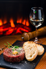 Beef steak tartare with raw egg yolk. French cuisine.
