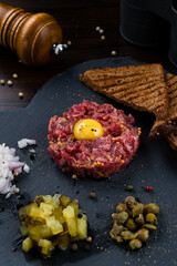 Beef steak tartare with raw egg yolk. French cuisine.