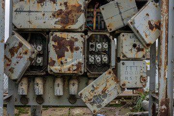 Old porcelain electrical fuses in an old switchboard on the shore of a historic shipyard 