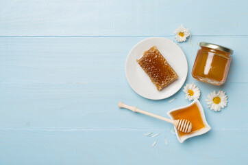 Composition with fresh honey on wooden background, top view