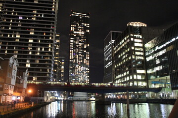 City skyline with train and water at night