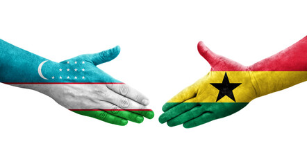 Handshake between Uzbekistan and Ghana flags painted on hands, isolated transparent image.