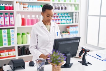African american woman pharmacist using computer at pharmacy