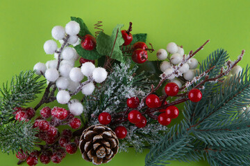 Christmas decoration. Top view on green pine tree branch, cone, red, white winter berries. Happy new year concept