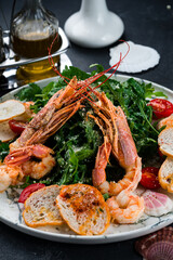 Salad with grilled giant langoustine shrimp, prawns and arugula