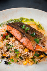 Fried salmon steak. Asian dish. Fried salmon with rice and vegetables