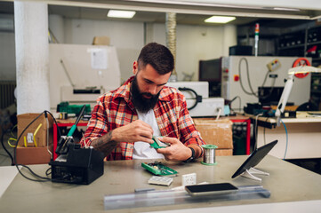 Electronics engineer man repairing computer part in service center