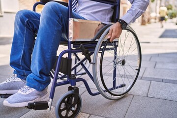 Obraz premium Middle age hispanic man wearing business clothes sitting on wheelchair at street