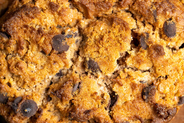 Delicious cookies with pieces of chocolate on the table