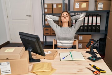 Young blonde woman ecommerce business worker relaxed with hands on head at office