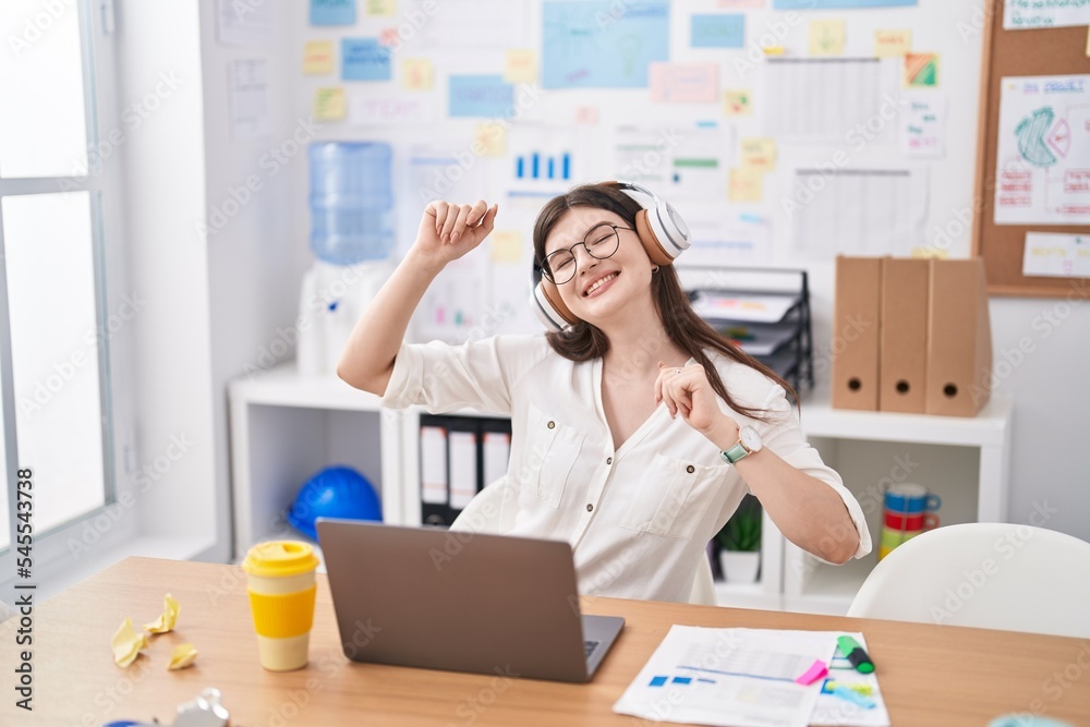 Sticker young caucasian woman business worker listening to music and dancing at office