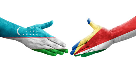 Handshake between Uzbekistan and Seychelles flags painted on hands, isolated transparent image.