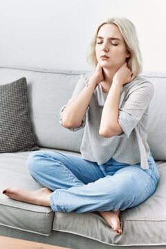 Young caucasian woman have neck pain at home