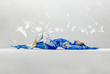 young sexy Woman in underwear, sportswear, artistically abstract painted with white and blue paint,...