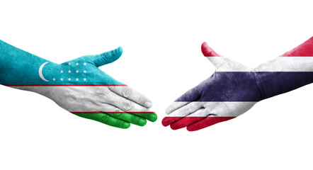 Handshake between Uzbekistan and Thailand flags painted on hands, isolated transparent image.