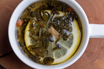 Green tea in a white cup during its brewing