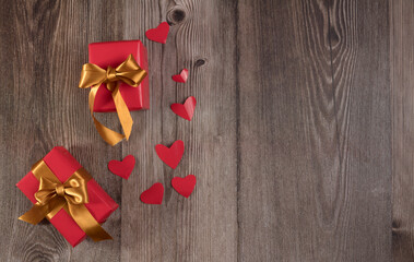 Gifts and hearts on wooden table
