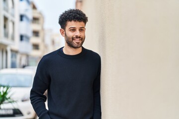 Young arab man smiling confident standing at street