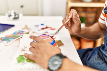 Obraz na płótnie Canvas Artist man painting ceramic at art studio.