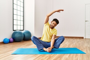 Young arab sporty man concentrate training yoga at sport center.