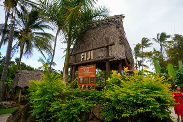 Laie, Hawaii - February 21, 2022 : Palm thatch-roofed open hall as part of the Polynesian Cultural Center on the North Shore of O'ahu island in Hawaii, United States - obrazy, fototapety, plakaty