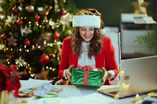happy business woman in green office with Christmas tree