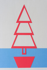 red holiday tree on blue and blank paper