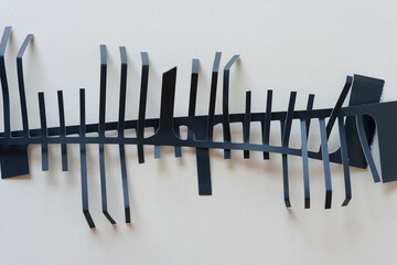 black paper object with fringe