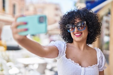 Young middle east woman smiling confident make selfie by smartphone at street