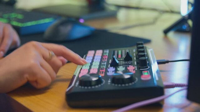 Close up of female vlogger using  editing console  for live stream - shot in slow motion