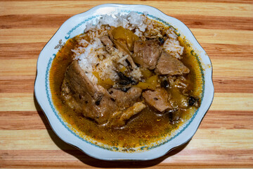 Stewed pork with mushrooms and rice on juice
