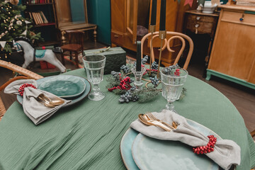 New Year's table setting Christmas in the style of the new year's fifties rustic antique style. decorated apartment without food with plates, candles and Christmas trees
