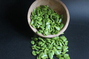 lamtoro seeds on a black background