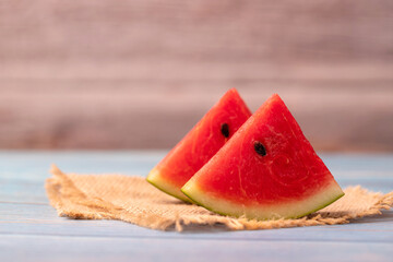 2 Pieces of juicy watermelon on a wooden table