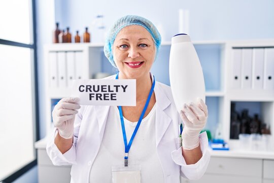 Middle age caucasian woman working on cruelty free laboratory smiling with a happy and cool smile on face. showing teeth.