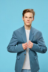 handsome young businessman buttoning up his suit