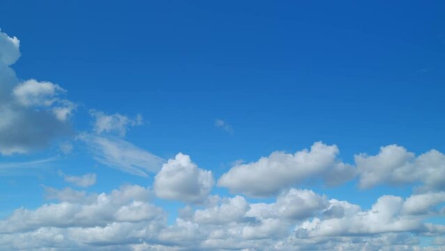 Beautiful blue sky with cumulus and cirrus on different layers clouds background. Sky with clouds weather nature cloud blue. Timelapse.
